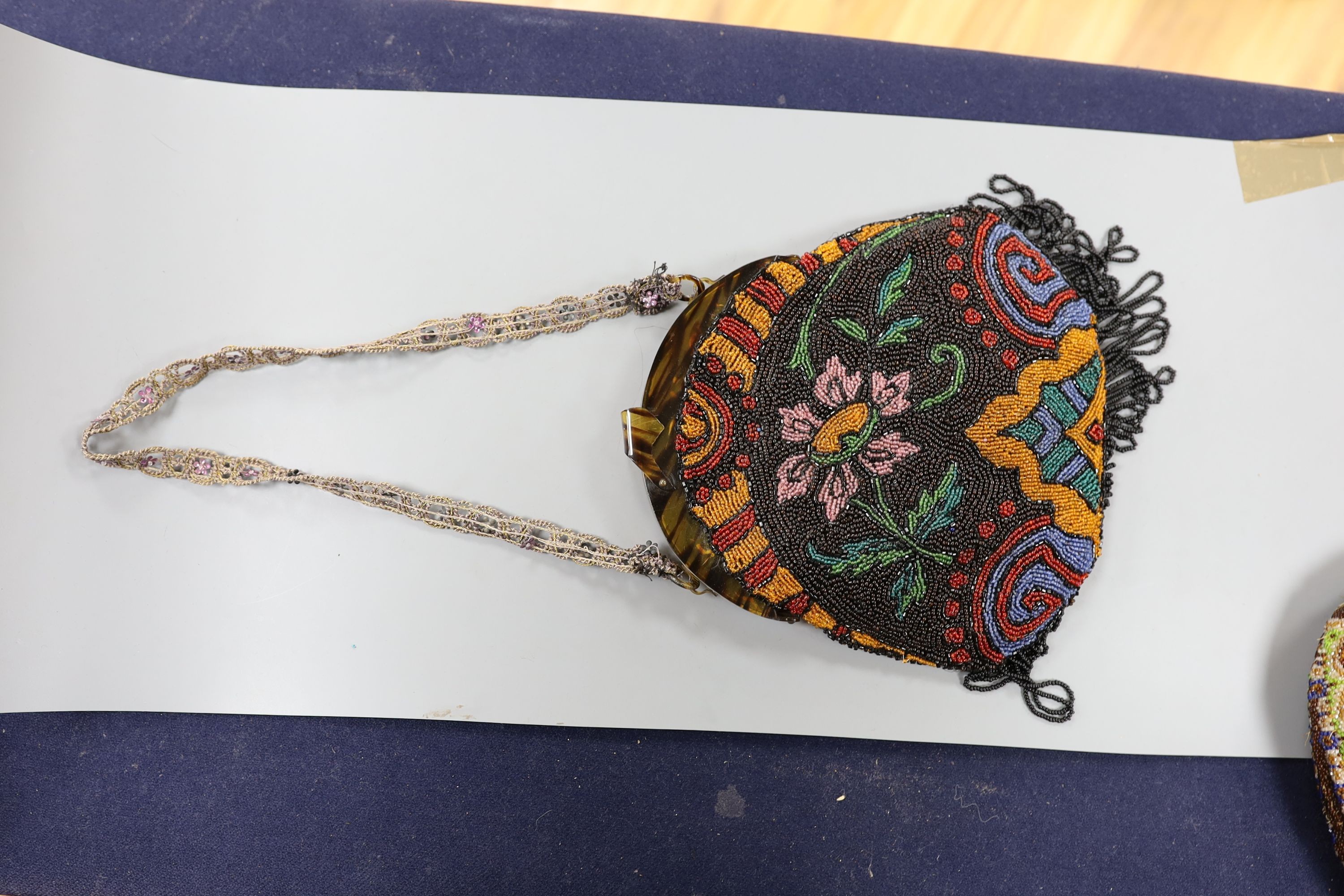 A fine needlework petit point evening bag, a 19th century bible bag, an early 20th century beaded bag and a 1930's beaded bag